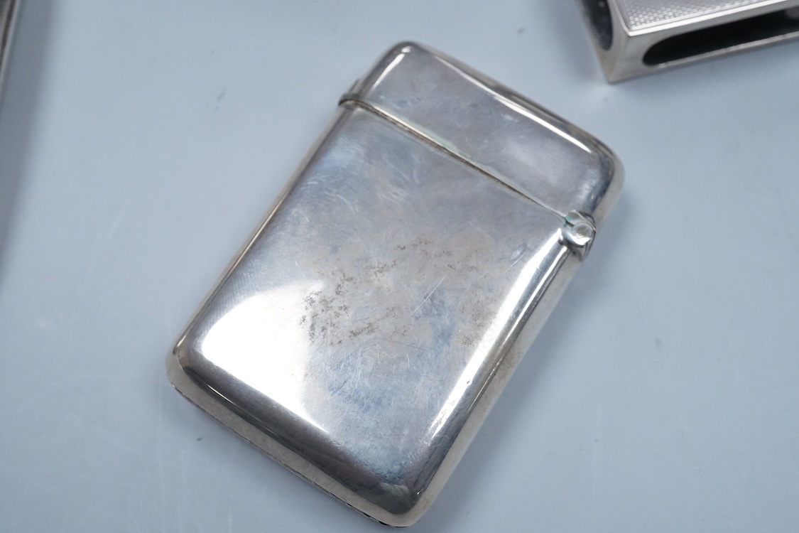 A George V engraved silver cigarette case, Birmingham, 1930, 82mm, a similar silver vesta case, London, 1913 and two silver matchbox sleeves.